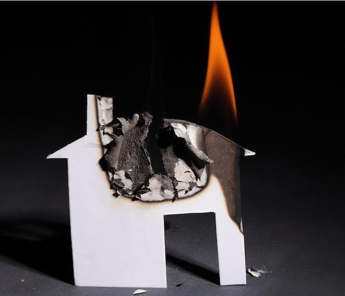 a small paper house burning