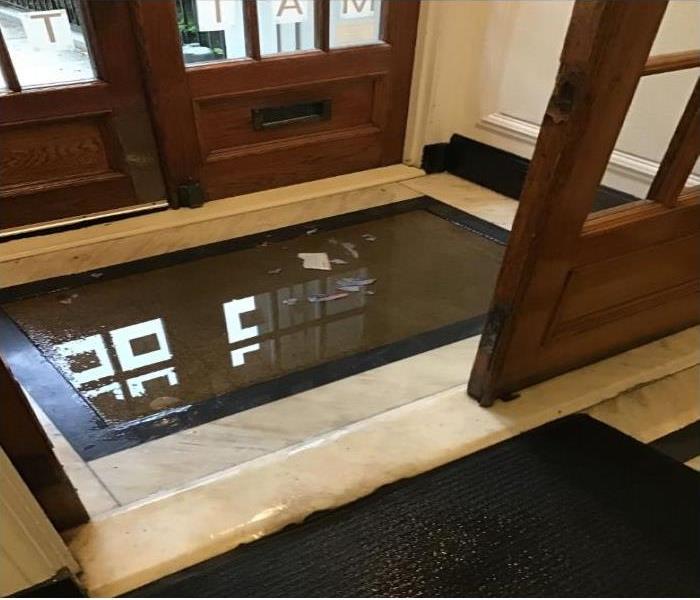 wet floor mat in entrance of building 