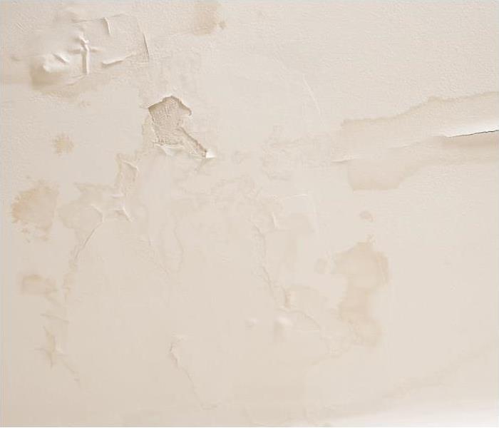 tan wall with water damage spots showing through