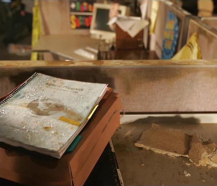 a workspace and cubicle showing signs of water damage
