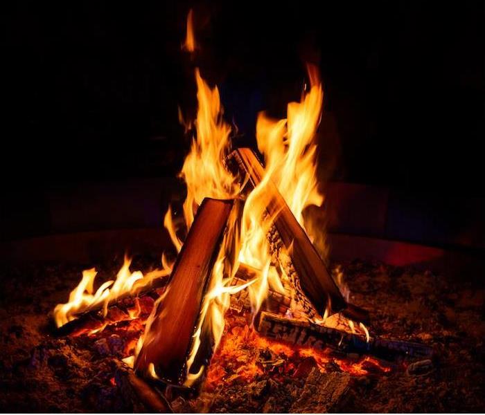 a small campfire burning bright in the dark night