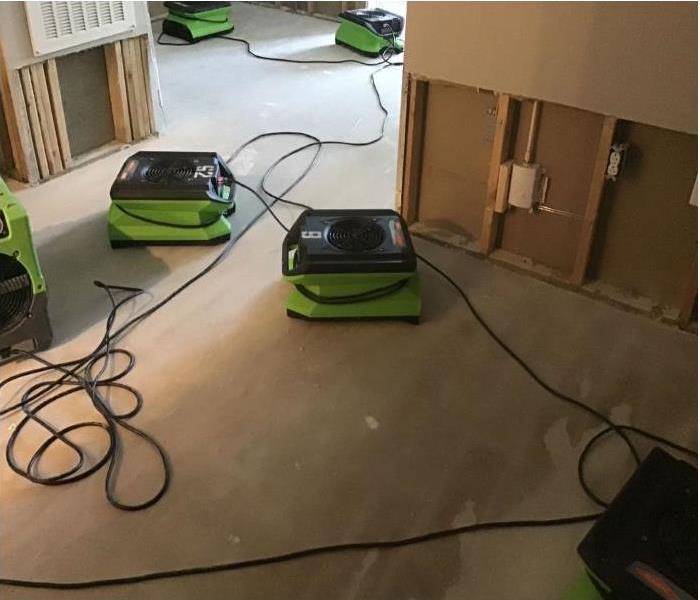 green drying equipment in office drying stud wall and floors