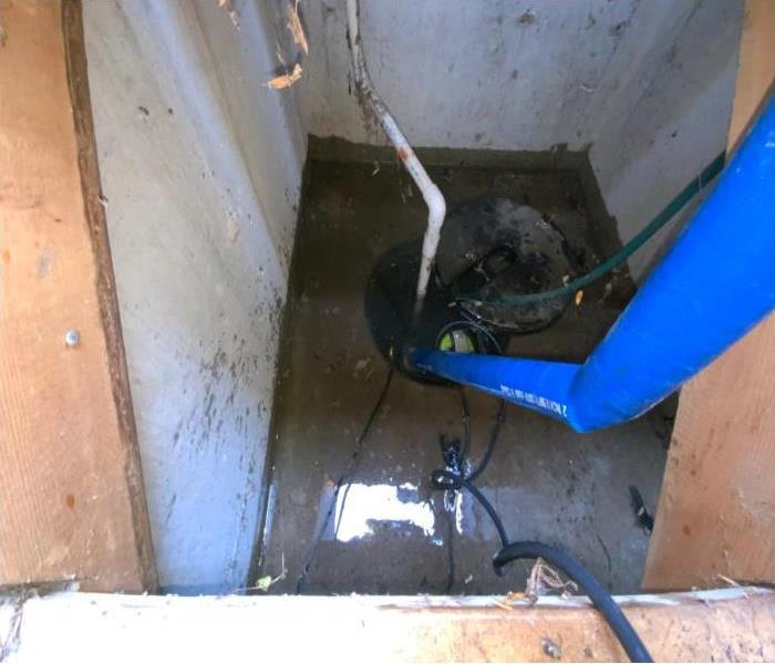 blue tube in elevator pit filled with water